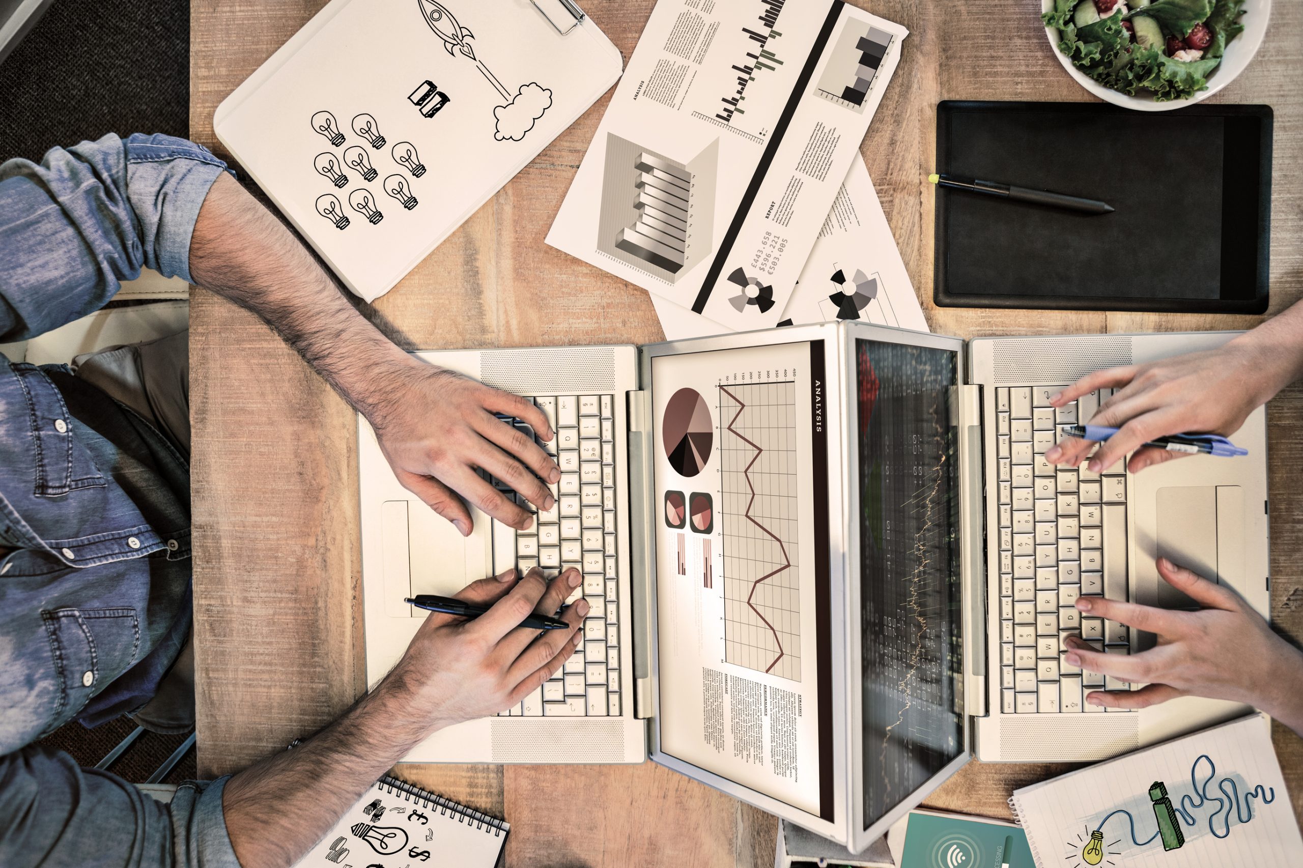 Two people working on their laptops doing seo for clients