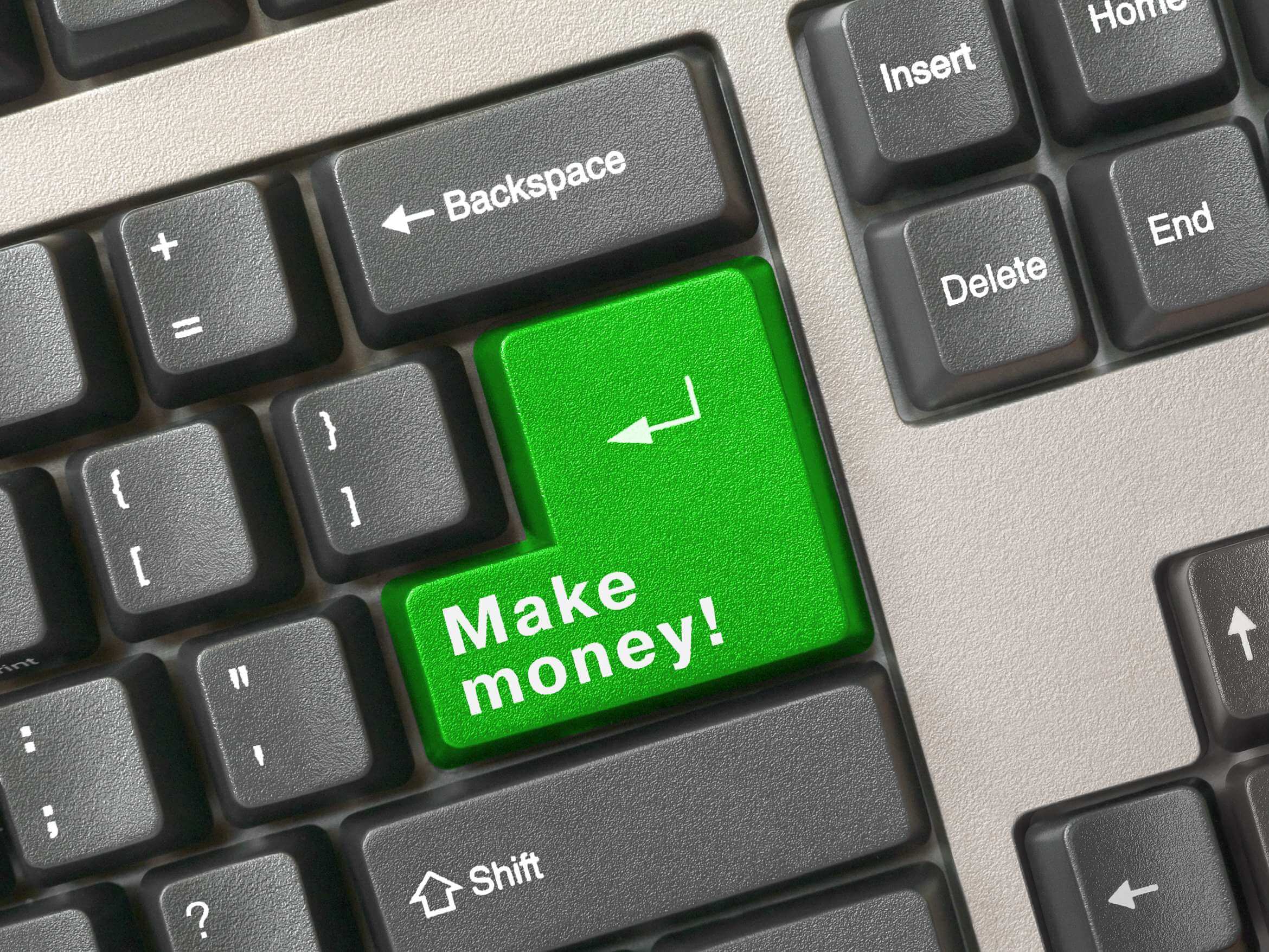 A close-up of a computer keyboard where the 'Enter' key is bright green and printed with the words 'Make money!'.