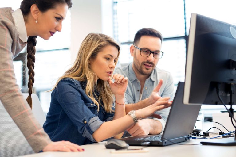 Professional team collaborating on a digital marketing strategy in an office setting